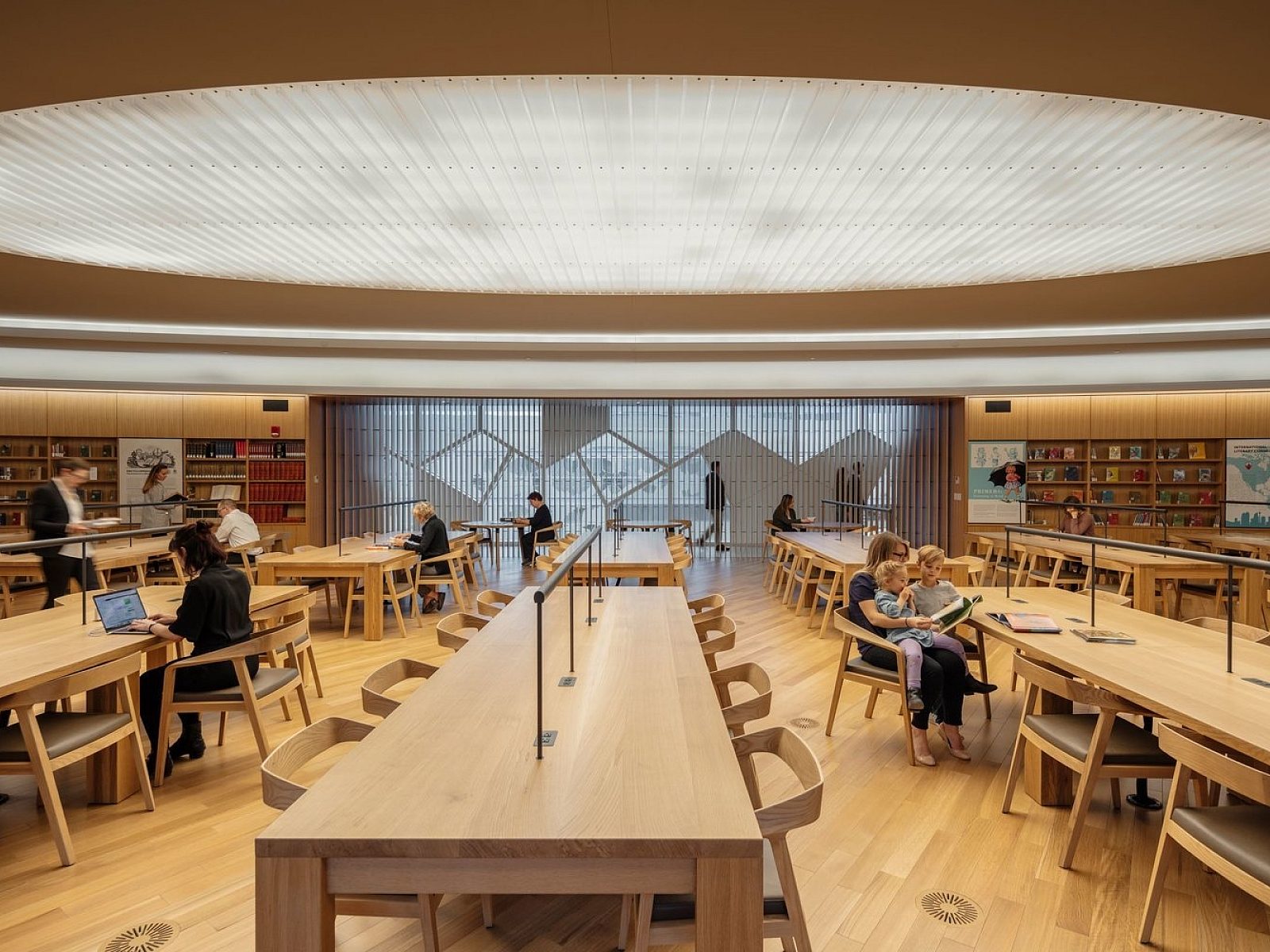 modern library with tables and chairs in a wood finish